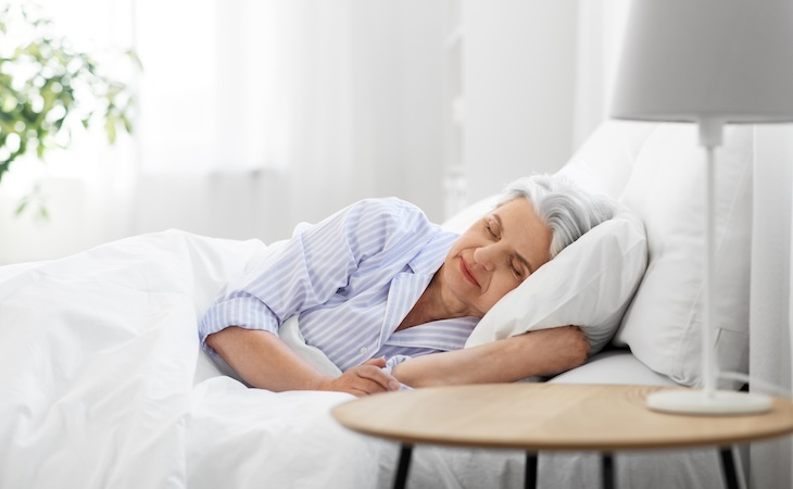 senior woman sleeping in bed at home bedroom