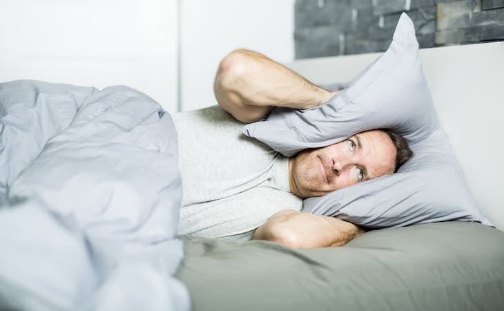 person sleeping with tinnitus