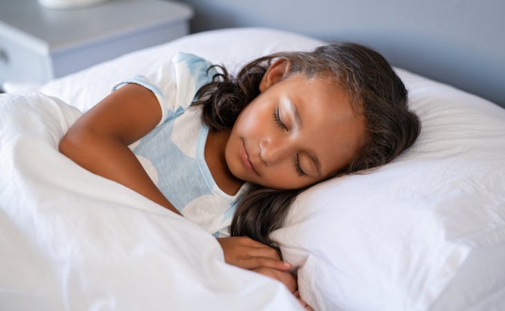 child sleeping in bed