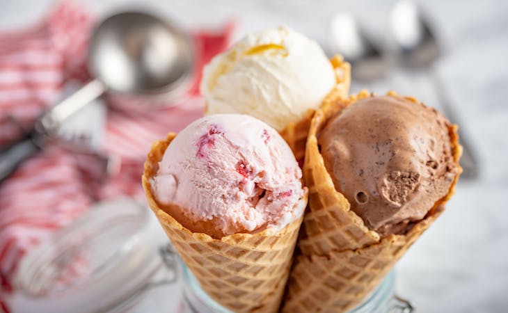 three cones with vanilla, chocolate, and strawberry ice cream