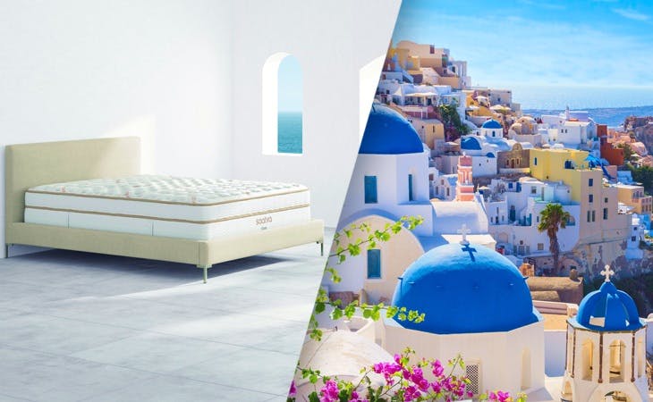 white buildings with blue domes on Santorini coastline, next to Saatva's Santorini platform bed frame
