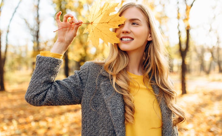 person holding leaf outside in the fall