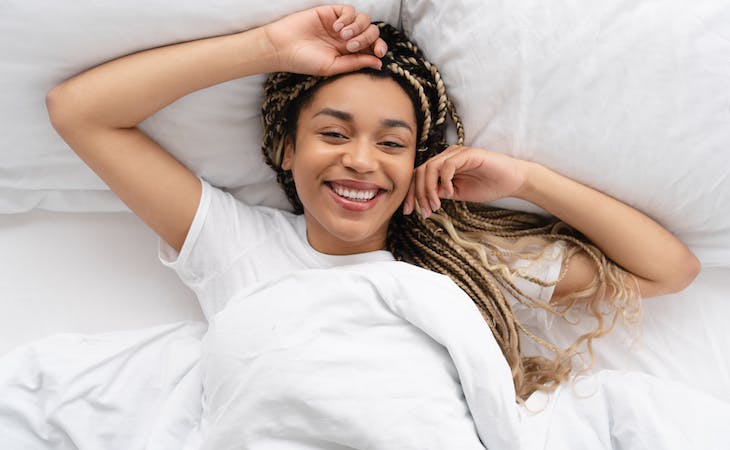 woman smiling in bed