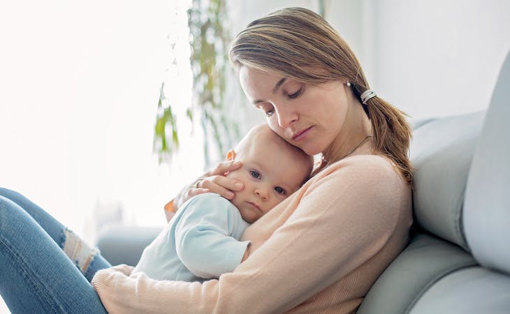sleep-deprived mom holding baby