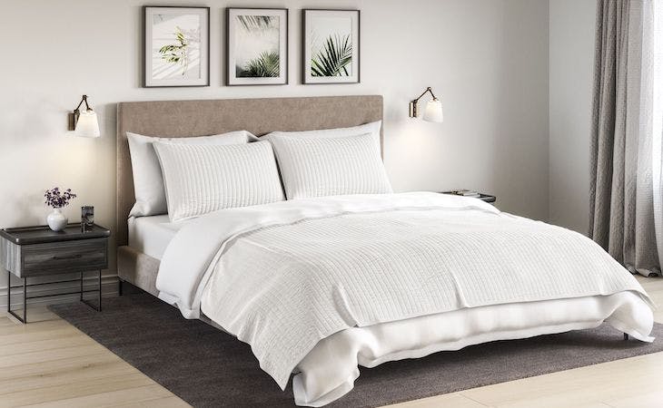 saatva cotton blanket on top of bed