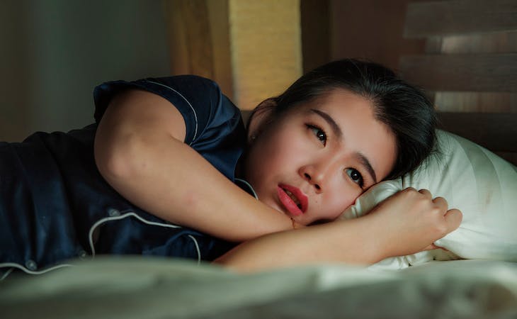 depressed person lying in bed