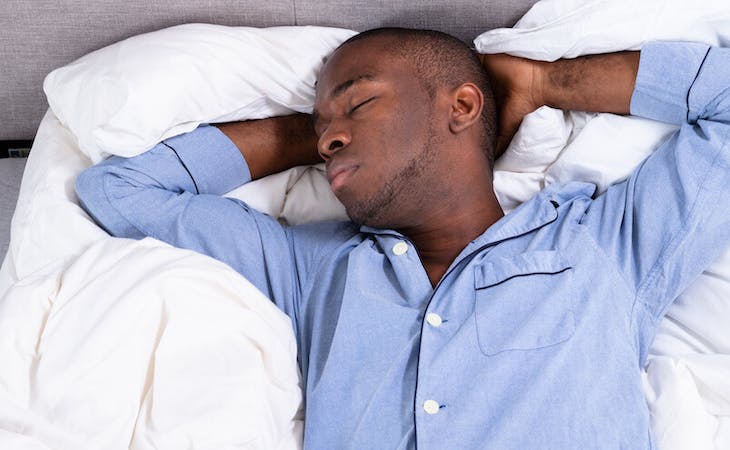 image of person sleeping on back in bed