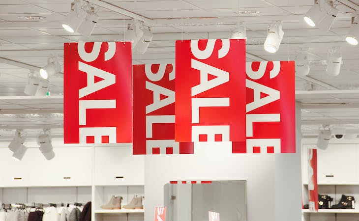 image of red sale signs - best time to buy a mattress