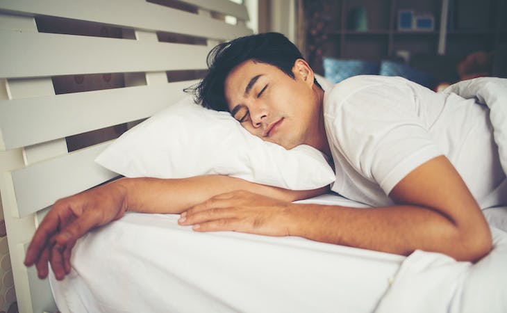 person sleeping on pillow in bed