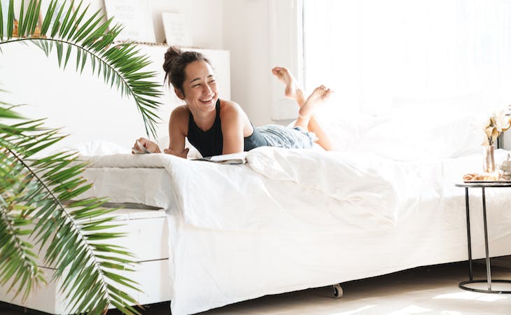 person lying on cooling sheets in bed