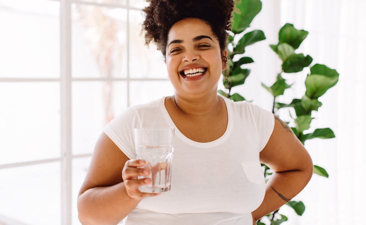 person holding glass of water