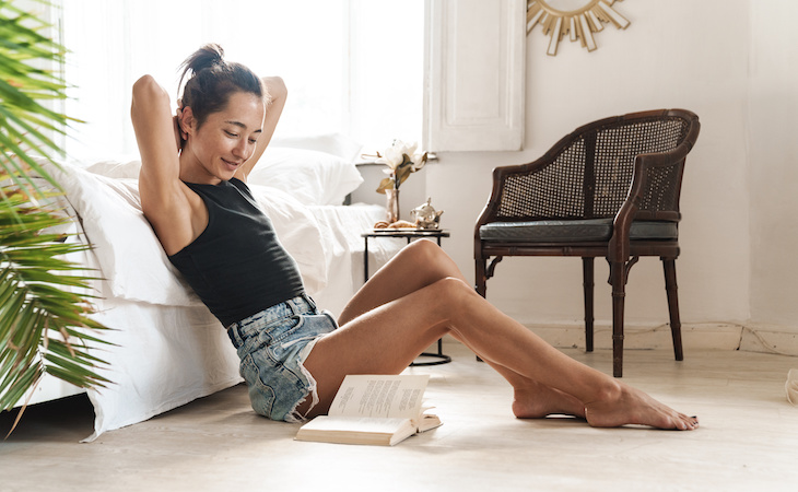 person sitting in bedroom during summer