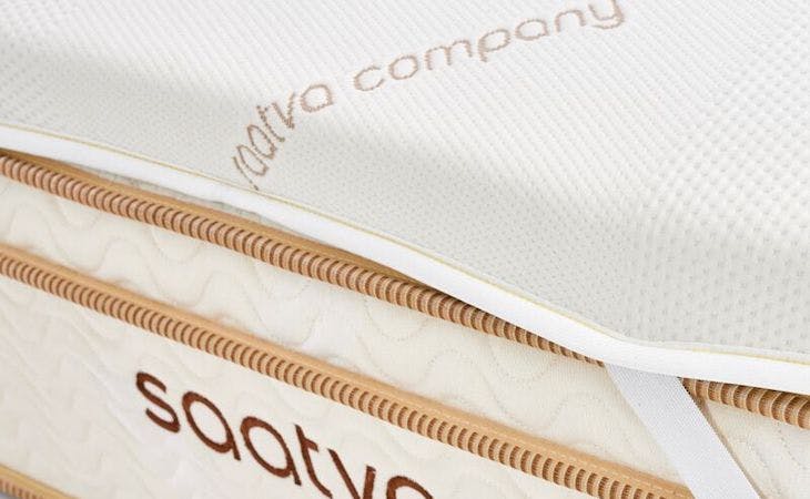 saatva mattress topper on top of bed