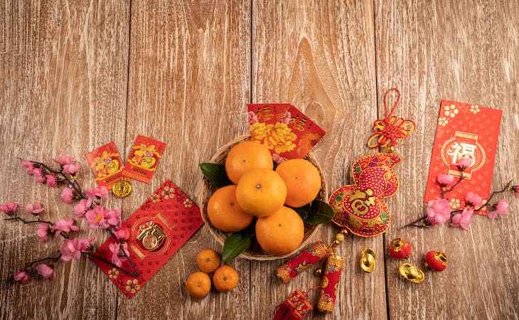 oranges, red envelopes, and gold coins for chinese new year