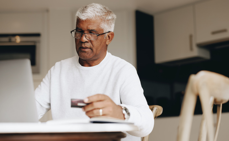 person shopping online for mattress and holding credit card