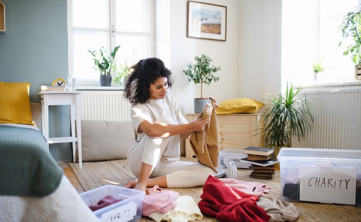 person decluttering bedroom