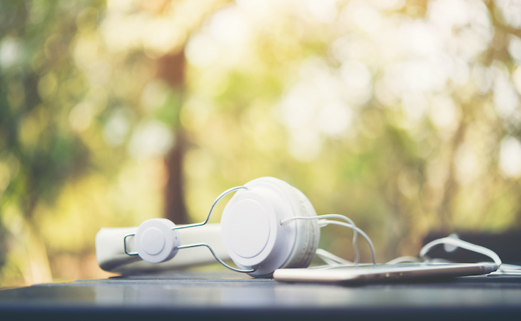 headphones outside in nature to symbolize green noise