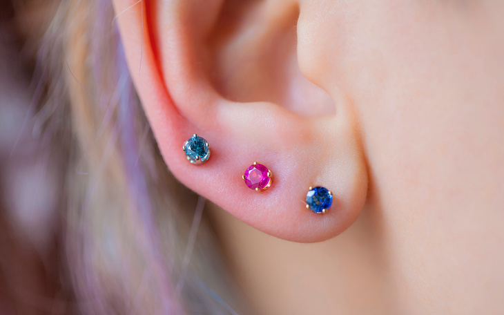 ear lobe with three ear piercings