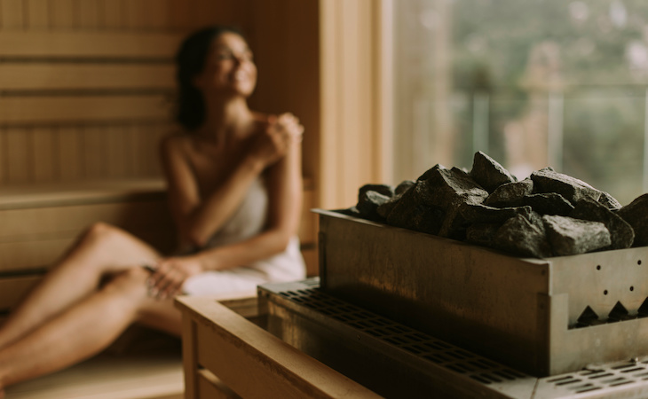 person relaxing in sauna