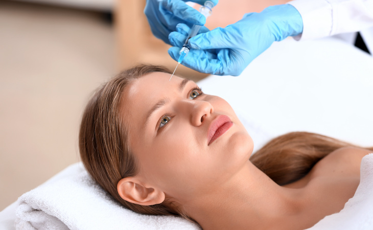 person getting botulinum toxin injection in forehead