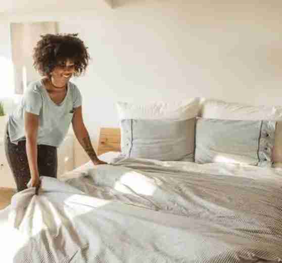 woman making her new bed iStock 1024724962