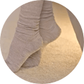 Feet touching the ground with a lit path from the Saatva Adjustable Base Plus